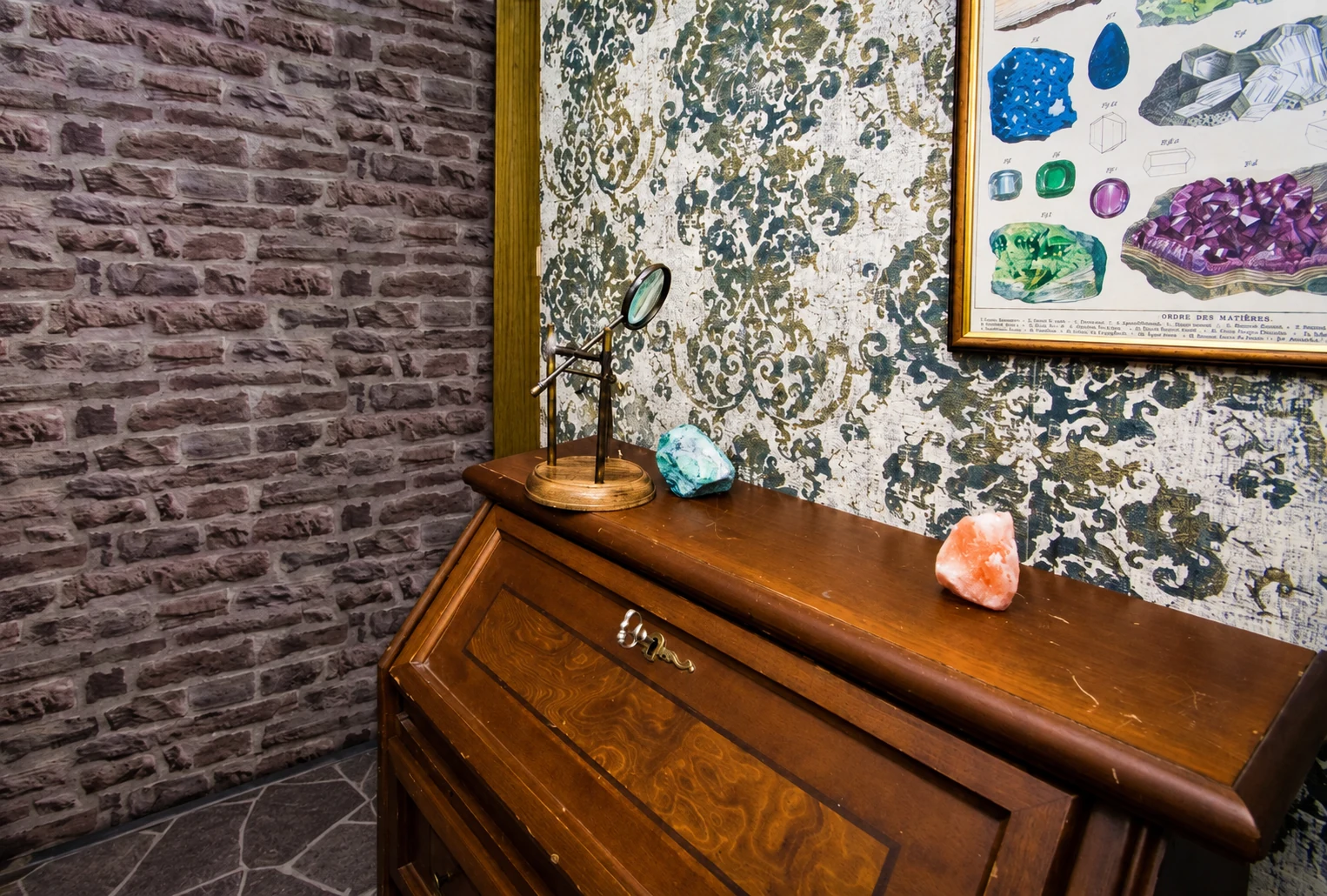 Minerals and a magnifying glass on the antique writing desk